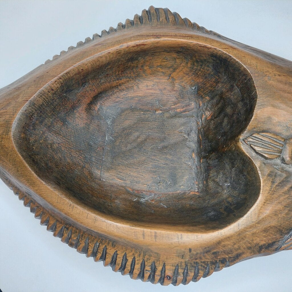 This is a Coast Salish Northwest Coast Cedar Halibut bowl carved and signed by Master Carver Simon Charlie 1979.
This Coast Salish Cedar Halibut Bowl is 16 1/4 inches (41.25cm) long and 8 inches (20.25cm) wide and is 2 1/4 inches (5.25cm) high.
Simon Charlie, known by his traditional name Hwunumetse', was a member of the Cowichan Tribes in Duncan, on Vancouver Island in BC. Simon Charlie is a Master Carver and a respected cultural leader. His work is significant to the oral traditions.