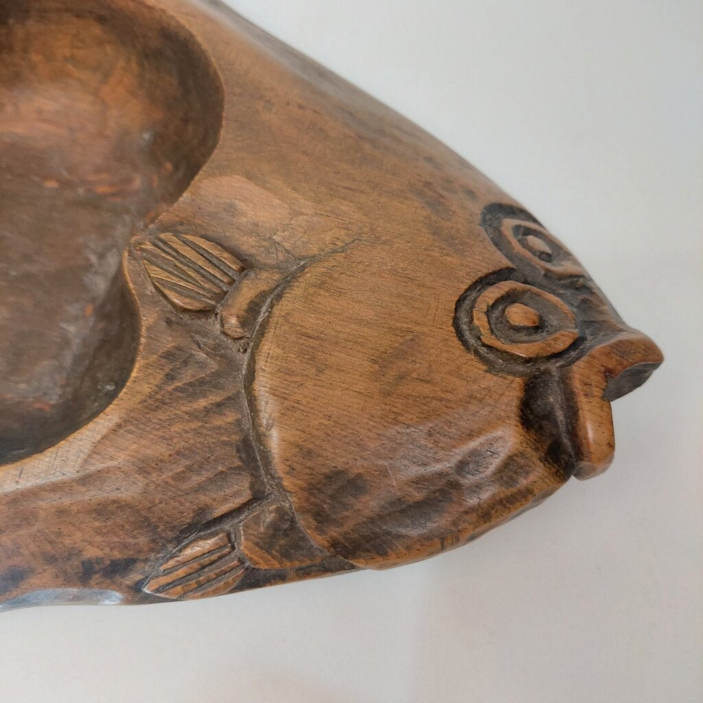 This is a Coast Salish Northwest Coast Cedar Halibut bowl carved and signed by Master Carver Simon Charlie 1979.
This Coast Salish Cedar Halibut Bowl is 16 1/4 inches (41.25cm) long and 8 inches (20.25cm) wide and is 2 1/4 inches (5.25cm) high.
Simon Charlie, known by his traditional name Hwunumetse', was a member of the Cowichan Tribes in Duncan, on Vancouver Island in BC. Simon Charlie is a Master Carver and a respected cultural leader. His work is significant to the oral traditions.