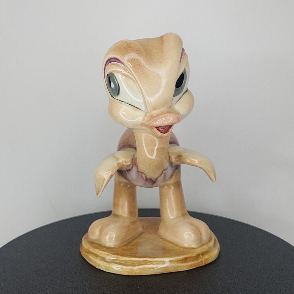 This is a David Hand's OSCAR OSTRICH Figurine 1154 of Animaland Series by Beswick England. 1949-1955
The Oscar Ostrich figurine is one of eight characters in David Hand's Animaland character series.
The figurine is 3-3/4 inches (9.5cm) tall.  
The backstamp is gold and reads: David Hand's Animaland, "Oscar Ostrich" Beswick England (circle) 35, Copyright by GB Animations Ltd.