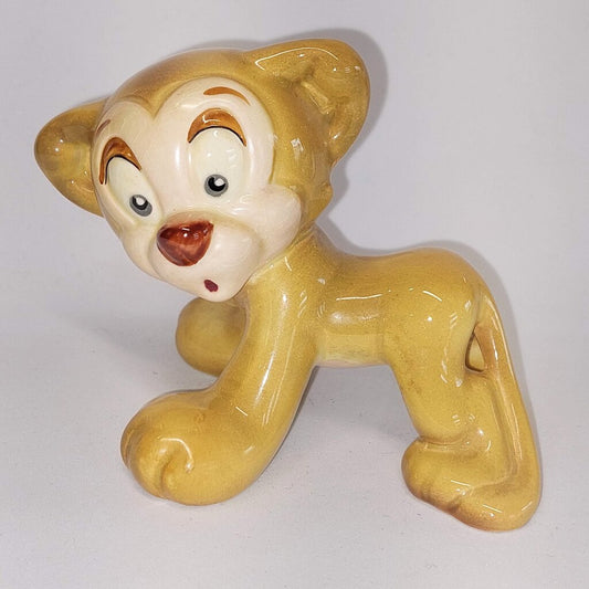 This is a David Hand's ZIMMY LION 1150 of Animaland Series by Beswick England. 1949-1955
The ZIMMY LION figurine is one of eight characters in David Hand's Animaland character series.
The figurine is 3-1/4 inches (8.25cm) tall.  
The backstamp is gold and reads: David Hand's Animaland, "Zimmy Lion 1150" Beswick England 6, Copyright by GB Animations Ltd.