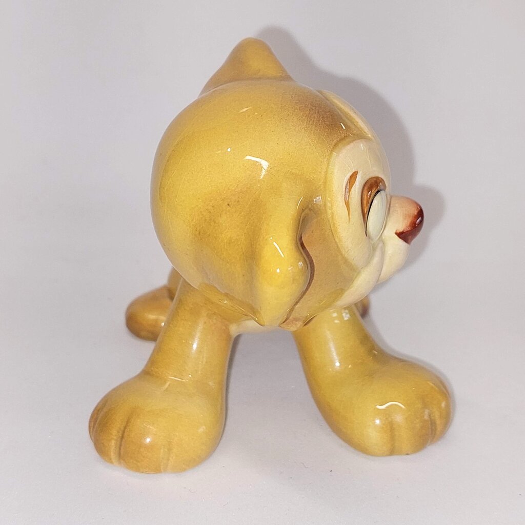This is a David Hand's ZIMMY LION 1150 of Animaland Series by Beswick England. 1949-1955
The ZIMMY LION figurine is one of eight characters in David Hand's Animaland character series.
The figurine is 3-1/4 inches (8.25cm) tall.  
The backstamp is gold and reads: David Hand's Animaland, "Zimmy Lion 1150" Beswick England 6, Copyright by GB Animations Ltd.