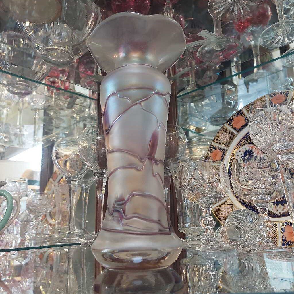 This is a 1960s - 70s Poschinger blown art glass vase. This piece is associated with Baron Von Poschinger and is hand blown with applied glass threads. 
The vase is iridescent with purple threads. 
The vase is 4.75 inches (12cm) wide at the top and is 10 inches (25.5cm) tall.
The vase is heavy at the bottom and opens to a flared rim.
A recognized Baron Von Poschinger design. 
In excellent condition. No chips, no cracks, no scratches, no repairs.