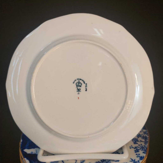 White plate with a blue logo on a dark background