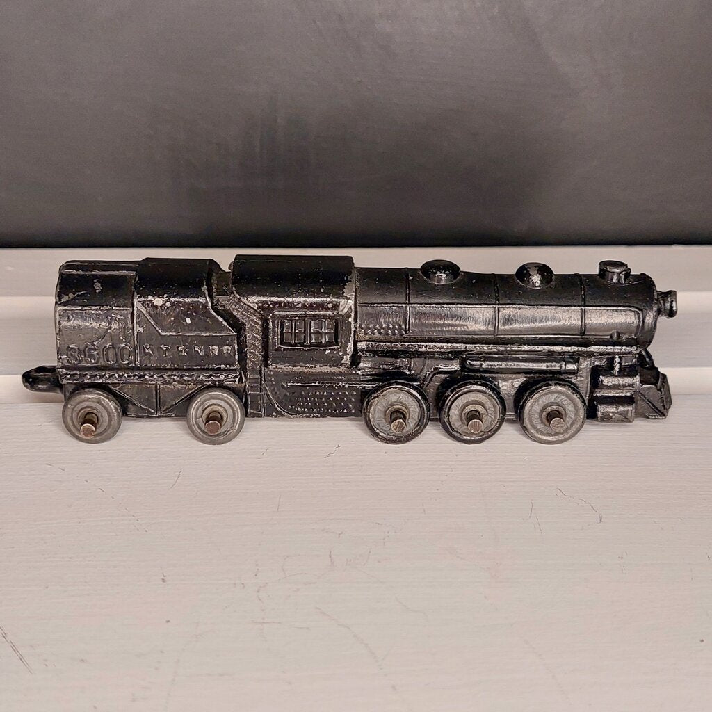 This is a vintage mid-century Toy Train Engine KT &amp; N RR 3600 cast metal with moving wheels.


This train is embossed with the letters KT &amp; N RR 3600 on both sides of this cast metal body.


This train engine measures 4.25 inches (11cm) long 1 inch (2.5cm) wide and 1 Inch (2.5cm) high.


The train has moving wheels which are intact and working as intended.


Very good vintage condition. Minimal wear.