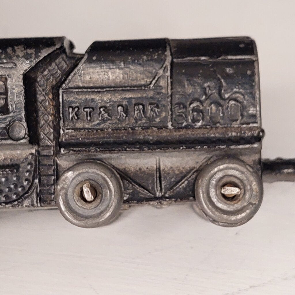 This is a vintage mid-century Toy Train Engine KT &amp; N RR 3600 cast metal with moving wheels.


This train is embossed with the letters KT &amp; N RR 3600 on both sides of this cast metal body.


This train engine measures 4.25 inches (11cm) long 1 inch (2.5cm) wide and 1 Inch (2.5cm) high.


The train has moving wheels which are intact and working as intended.


Very good vintage condition. Minimal wear.