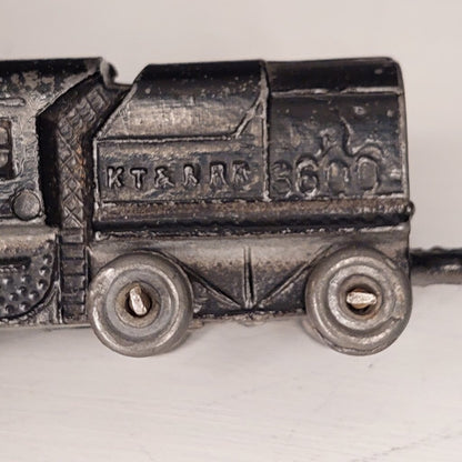 This is a vintage mid-century Toy Train Engine KT &amp; N RR 3600 cast metal with moving wheels.


This train is embossed with the letters KT &amp; N RR 3600 on both sides of this cast metal body.


This train engine measures 4.25 inches (11cm) long 1 inch (2.5cm) wide and 1 Inch (2.5cm) high.


The train has moving wheels which are intact and working as intended.


Very good vintage condition. Minimal wear.