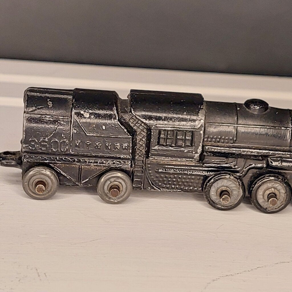 This is a vintage mid-century Toy Train Engine KT &amp; N RR 3600 cast metal with moving wheels.


This train is embossed with the letters KT &amp; N RR 3600 on both sides of this cast metal body.


This train engine measures 4.25 inches (11cm) long 1 inch (2.5cm) wide and 1 Inch (2.5cm) high.


The train has moving wheels which are intact and working as intended.


Very good vintage condition. Minimal wear.