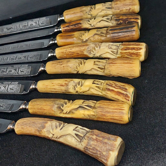  Karl Kimmel Solingen Germany Rostfrei (stainless) knife and fork set with carved stag antler handles and sharpening steel.

This antler handle flatware set includes 8 forks, 8 steak knives, and&nbsp;1 sharpening steel.
The front of each fork is decorated with an etched stag and each antler handle is hand carved with a calling standing stag..&nbsp;&nbsp;

The knives have a beautiful etched forest hunting scene that includes a running stag, a fence, a hunter aiming his rifle, and a dog
