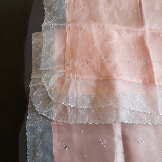 This is a 2 piece vintage pink bassinet, crib, or pram coverlet and sham with embroidered flowers.

This pink bassinet coverlet and sham are trimmed with sheer machine embroidered lace trim.
This bassinet,crib or pram coverlet has a sheer polyester layer on top that is embroidered with blue and pink flowers and a non-sheer polyester layer underneath.