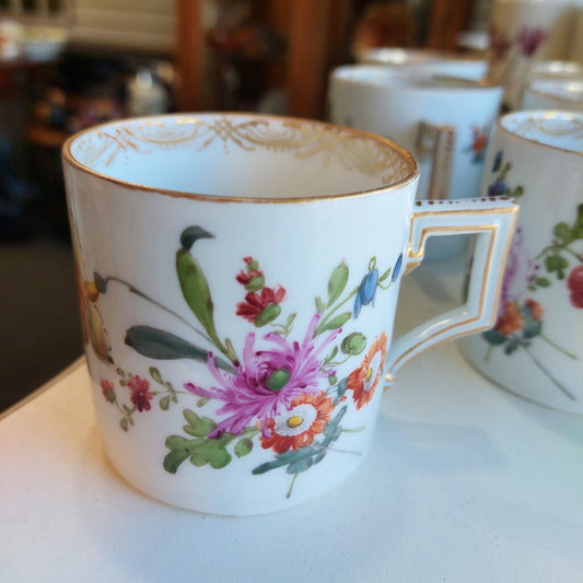 This is a 12 piece Meissen Dresden set of 6 Coupe Plates and 6 Coffee can cups in the Floral Sprays pattern.

There are 6 coffee cans and 6 coupe shaped dessert or fruit plates.

The dishes are hand painted with the Floral Sprays pattern with a large spray and individual flower sprays around it. The rim is decorated in a drape pattern in gold. Each can cup has a single flower painted in the bottom.