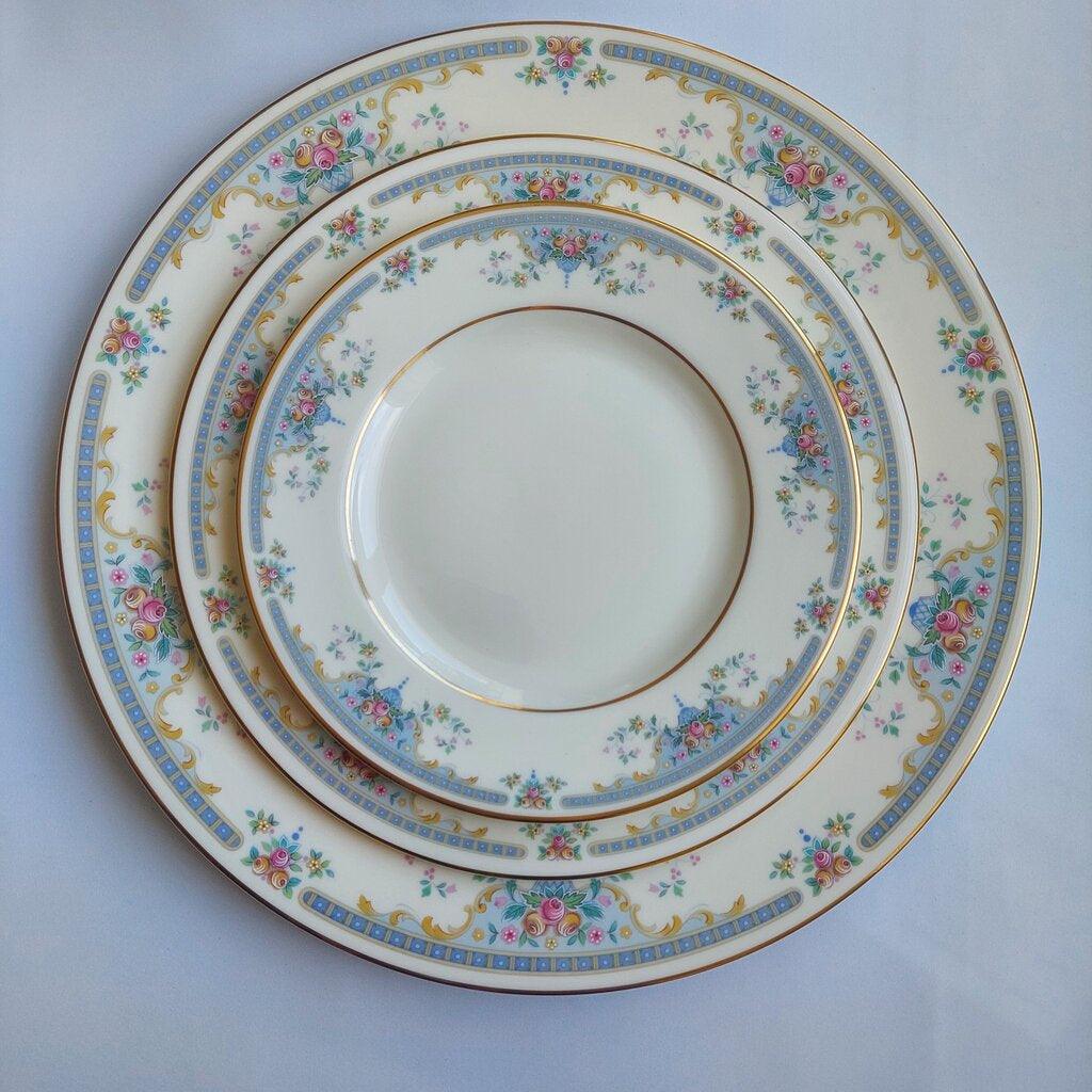 Set of three decorative ceramic plates with floral patterns on a light blue background