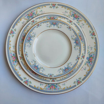 Set of three decorative ceramic plates with floral patterns on a light blue background