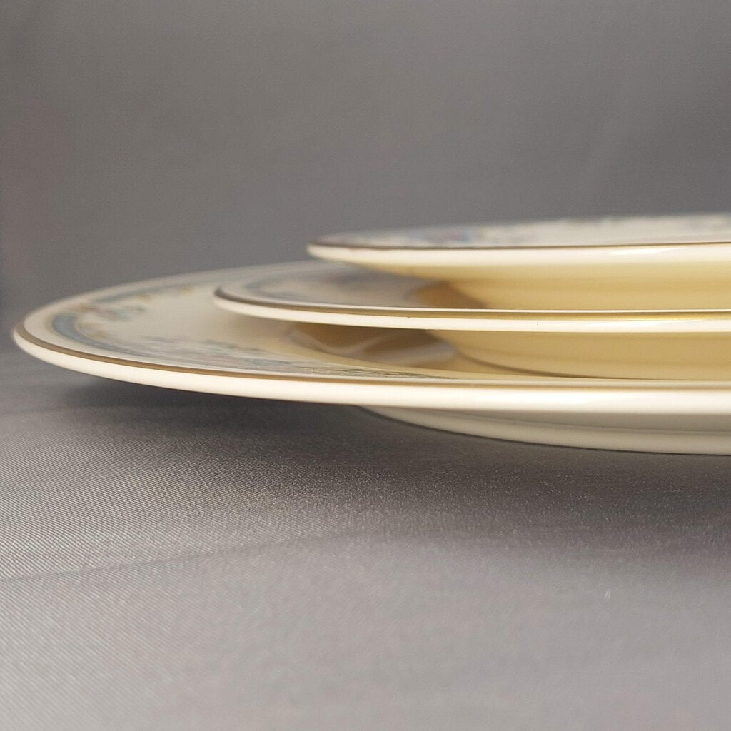Stack of decorative plates on a gray surface