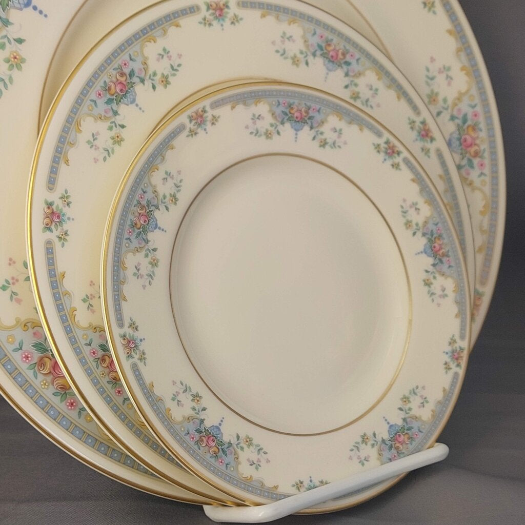 Set of decorative plates with floral patterns on a stand