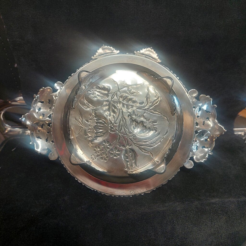 Silver bracelet with intricate design on a dark background