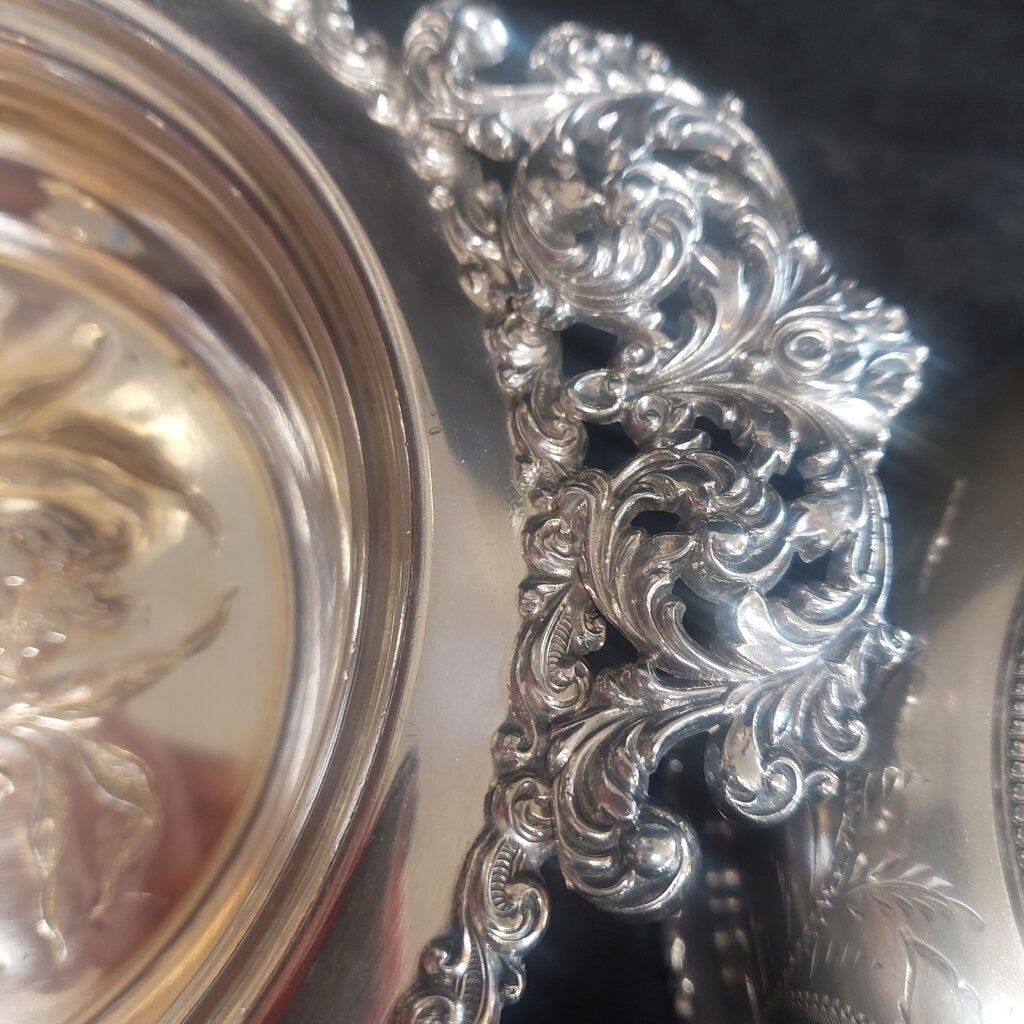 Close-up of an ornate silver platter with intricate designs.