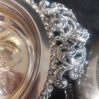 Close-up of an ornate silver platter with intricate designs.
