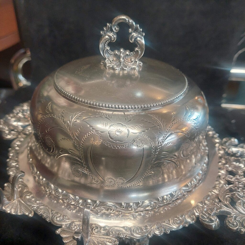 Decorative silver bowl with intricate designs on a matching stand.