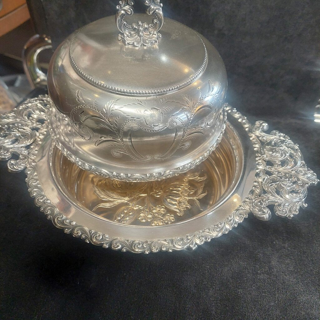 Silver decorative bowl with intricate designs on a dark surface