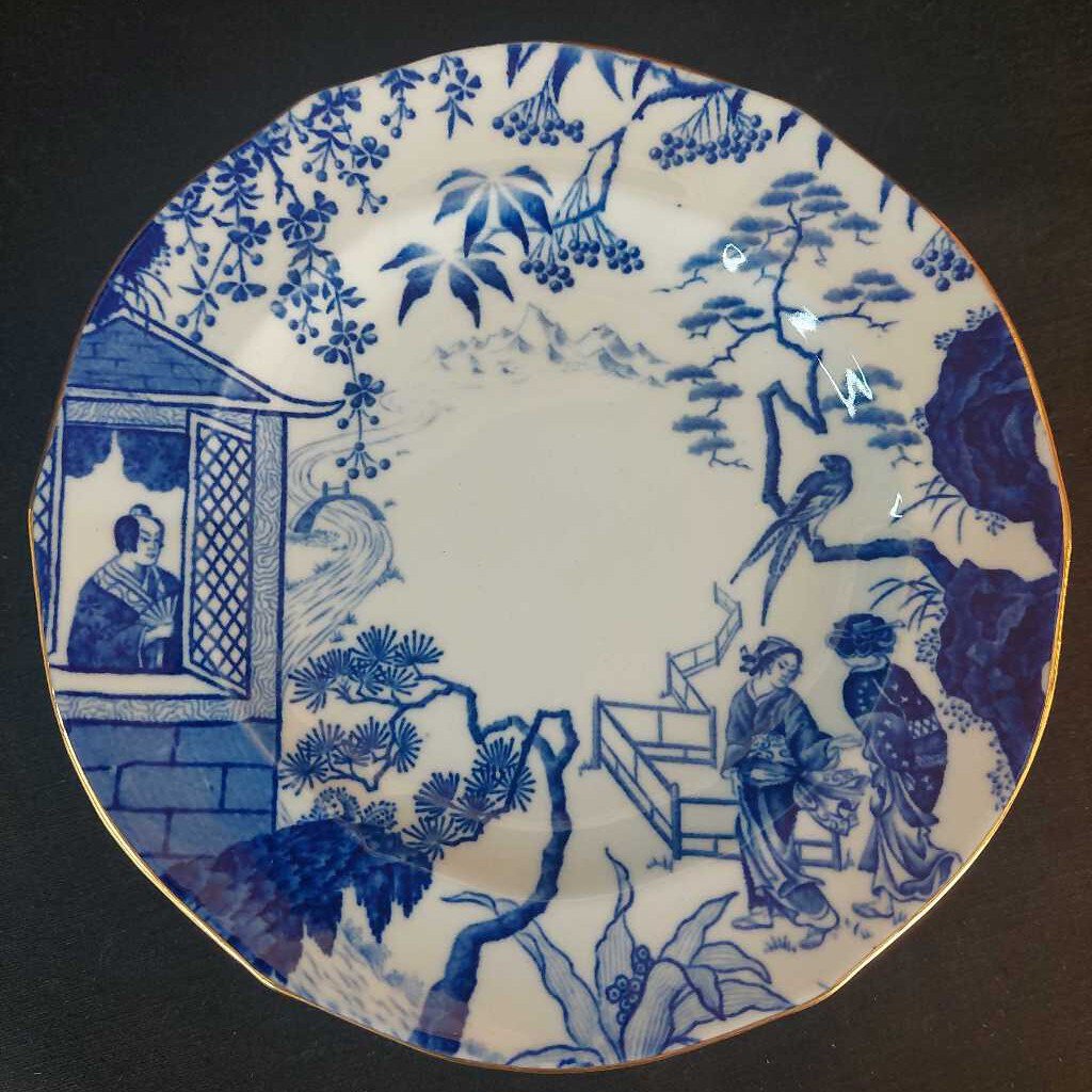 Blue and white ceramic plate with traditional design of people and nature